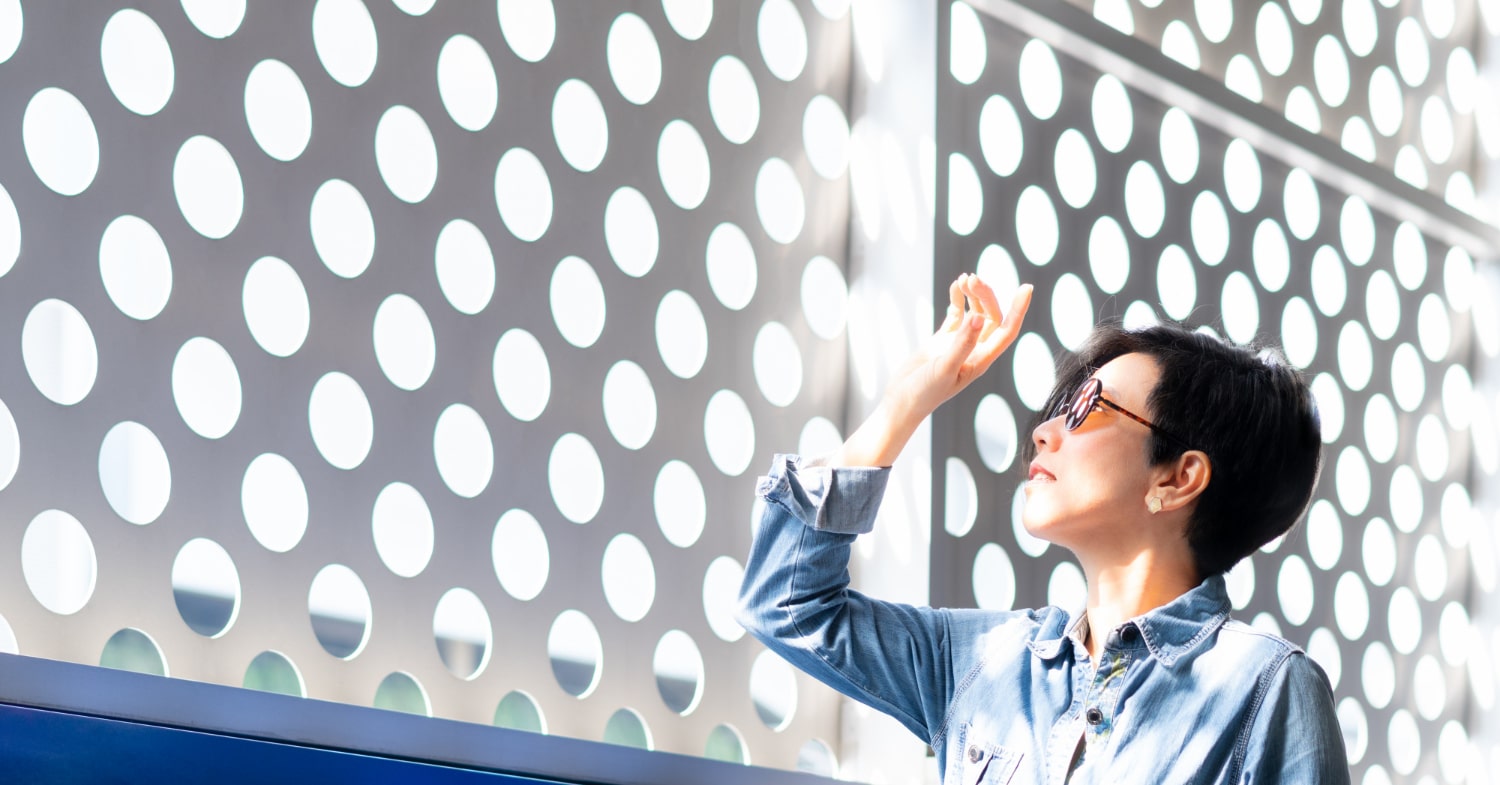 Woman looking into the sun