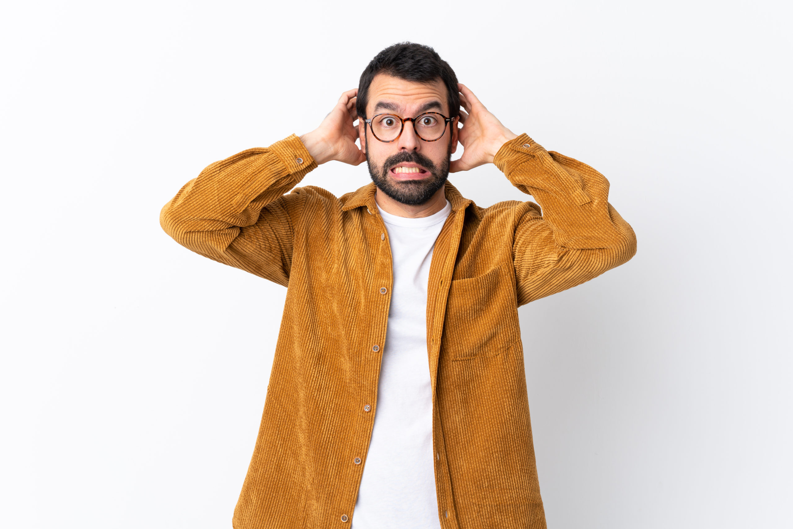 Man in glasses covering his ears